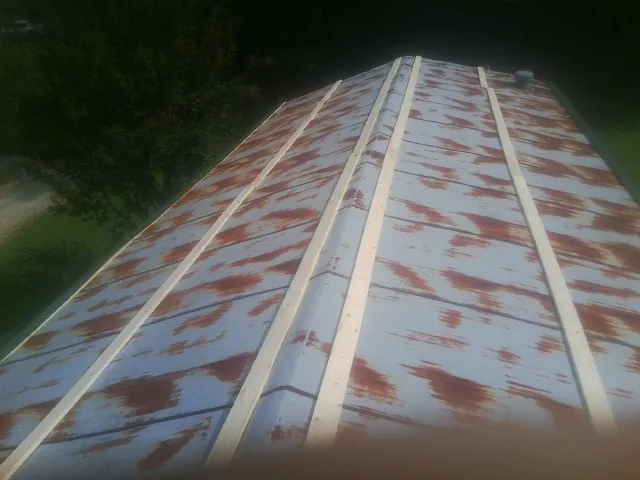 Rusted metal roof panels with new wood purlins before replacement — Storm Damage Roof Repair in Tremont by Roofing Brothers